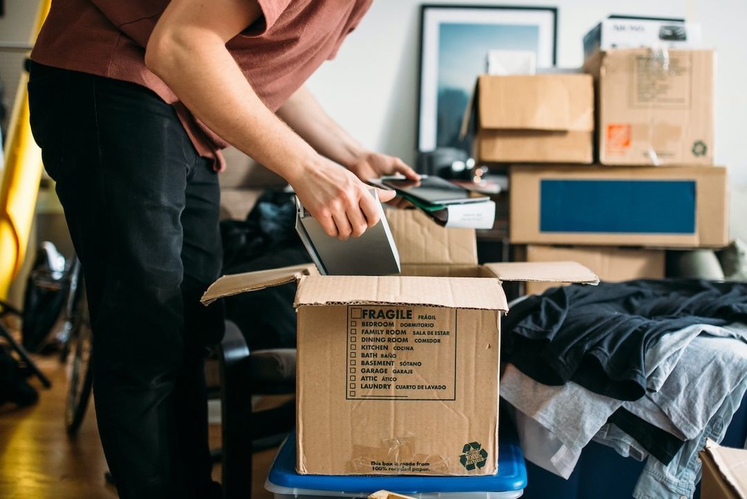 Person packing boxes at home while preparing to move