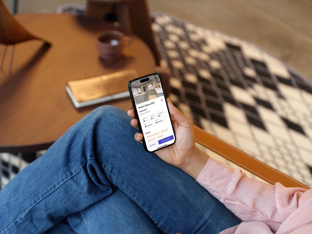 Person looking at a property app on their phone